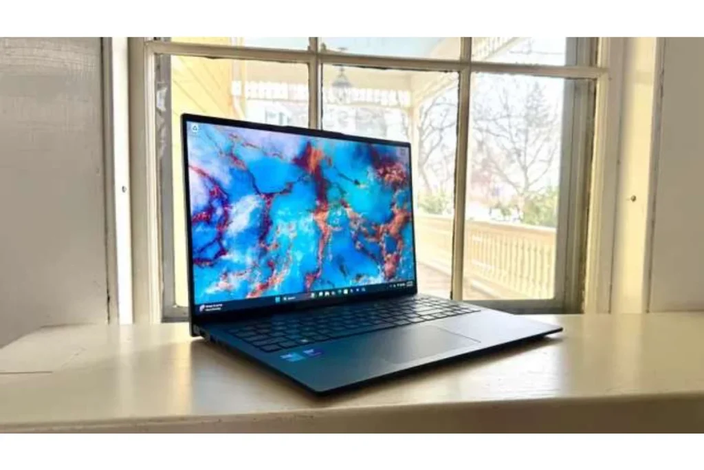 The slim Acer Swift 16 AI sitting on a wooden surface in front of a window, representing a versatile choice in the Best Student Laptops category.