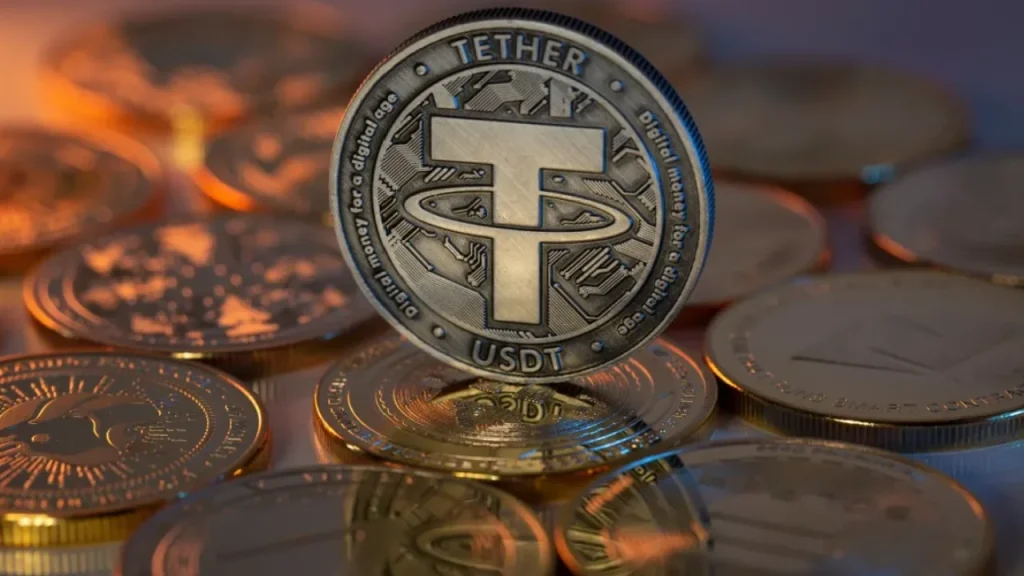 Silver Tether (USDT) coin with the T logo standing upright among other coins, lit with a warm orange glow.